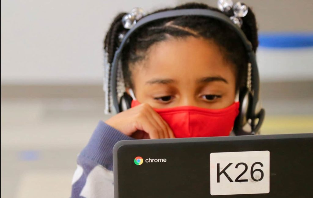 A student looks at their computer