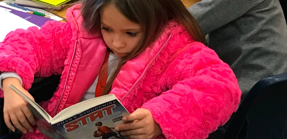 A young student reads a book